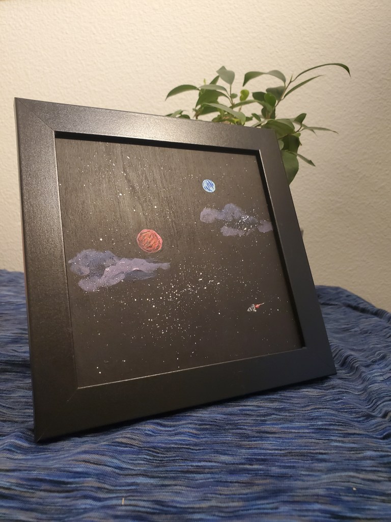 A painting of space, photographed in front of a plant.