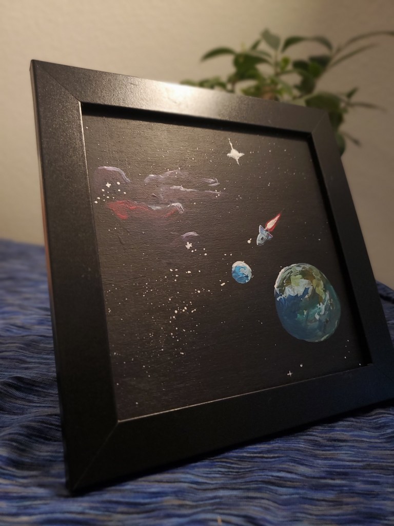 A painting of space, photographed in front of a plant.